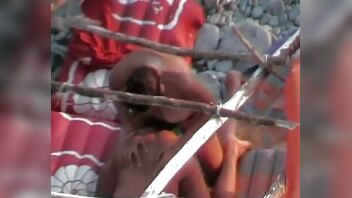 wife strap husband on beach